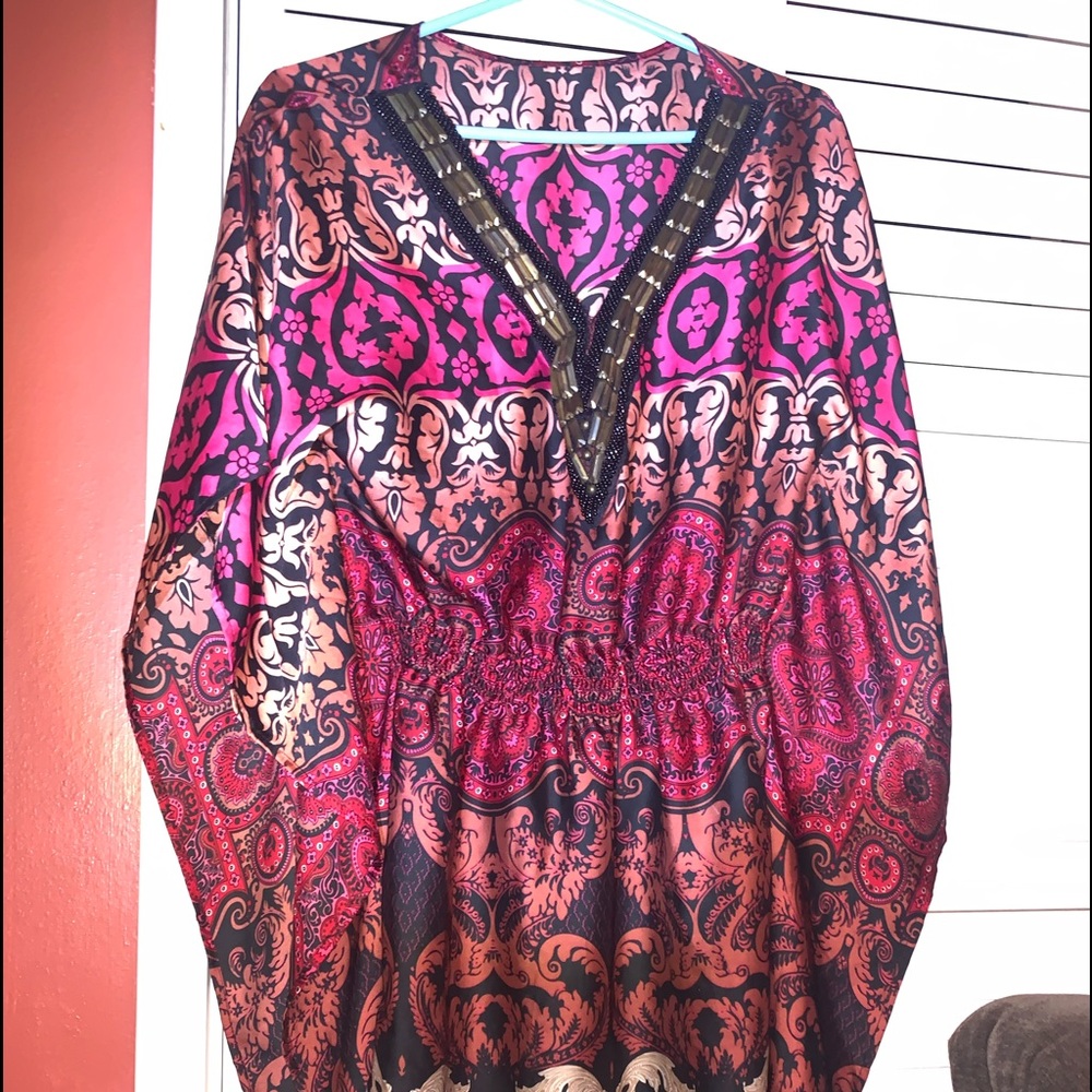 Woman’s blouse by BEBE front cut hand beaded polyester sleeveless open flare